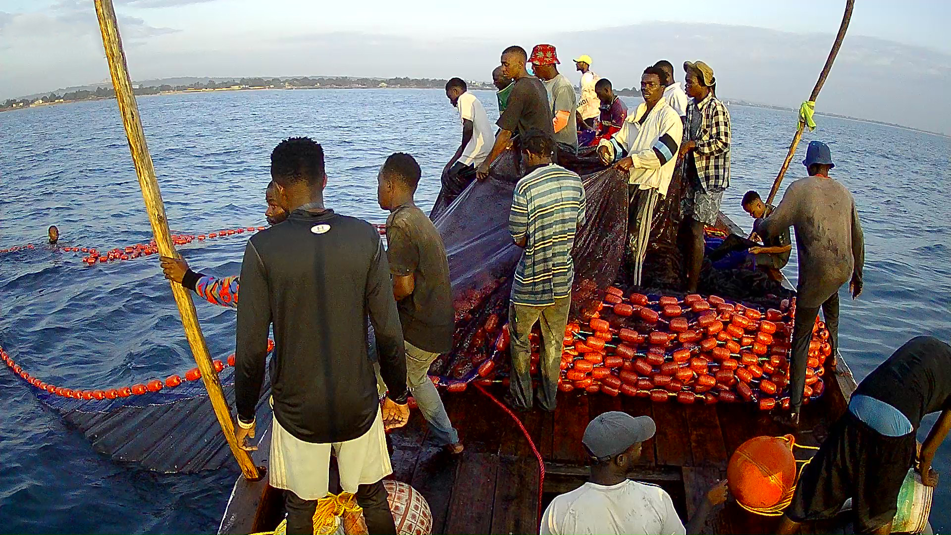 DPR fishermen hauling nets aboard a boat in the middle of the Indian Ocean